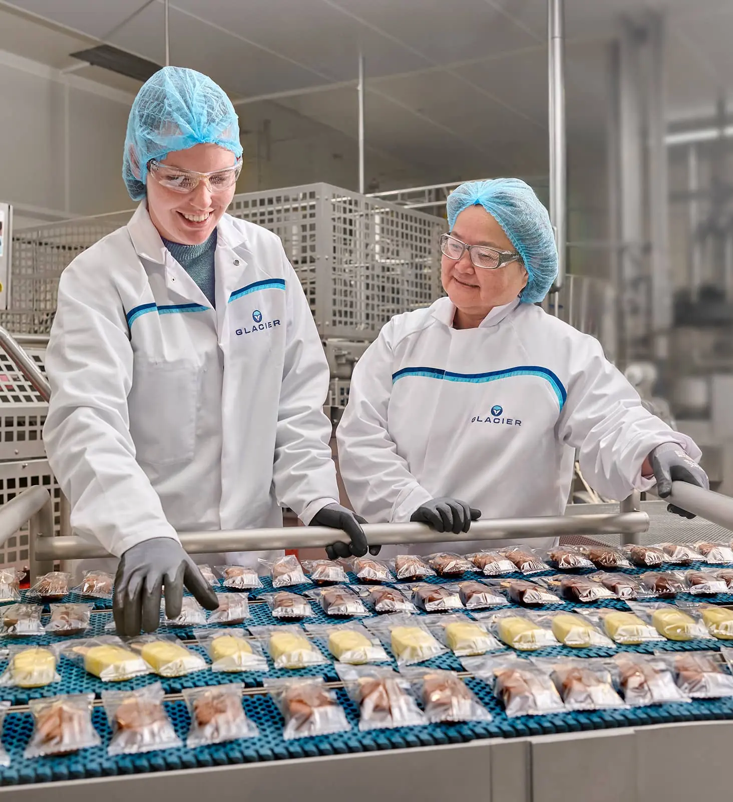 Image of two Glacier employees behind production.